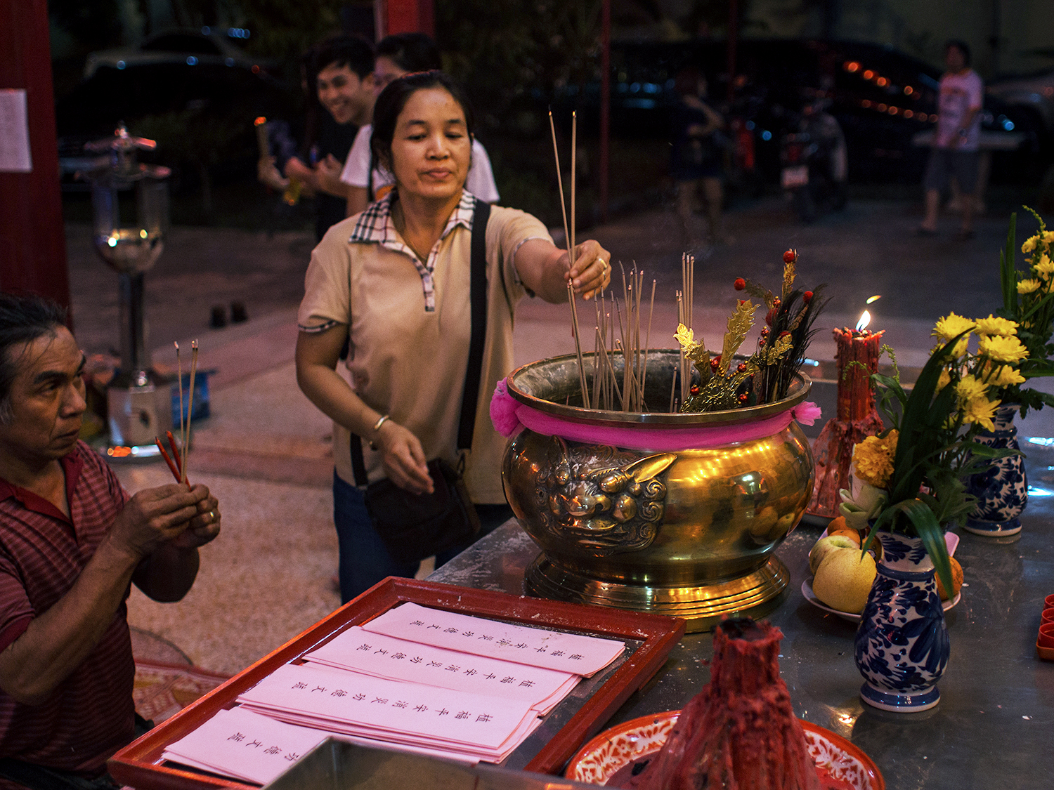 A woman in a Thai temple lighting