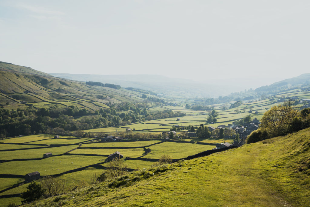 View of a green valley and fields in the Yorkshire Dales.