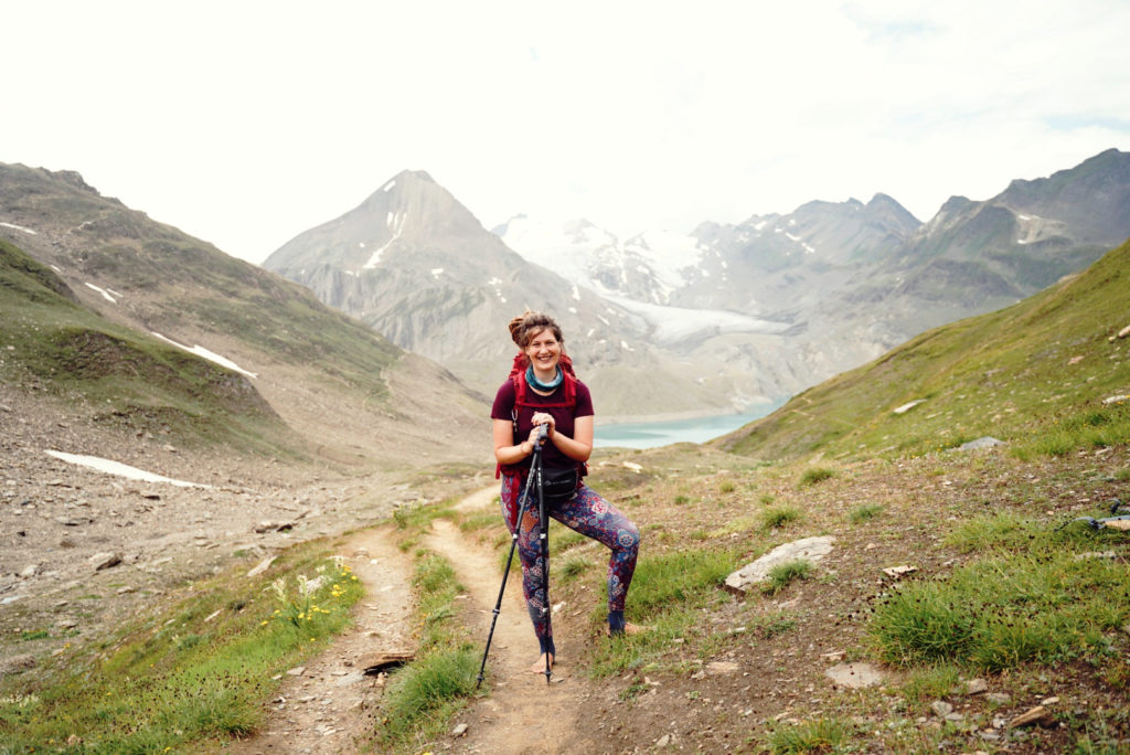 A solo hiker on the Grande Traversata delle Alpi, witha  glacier in the background.