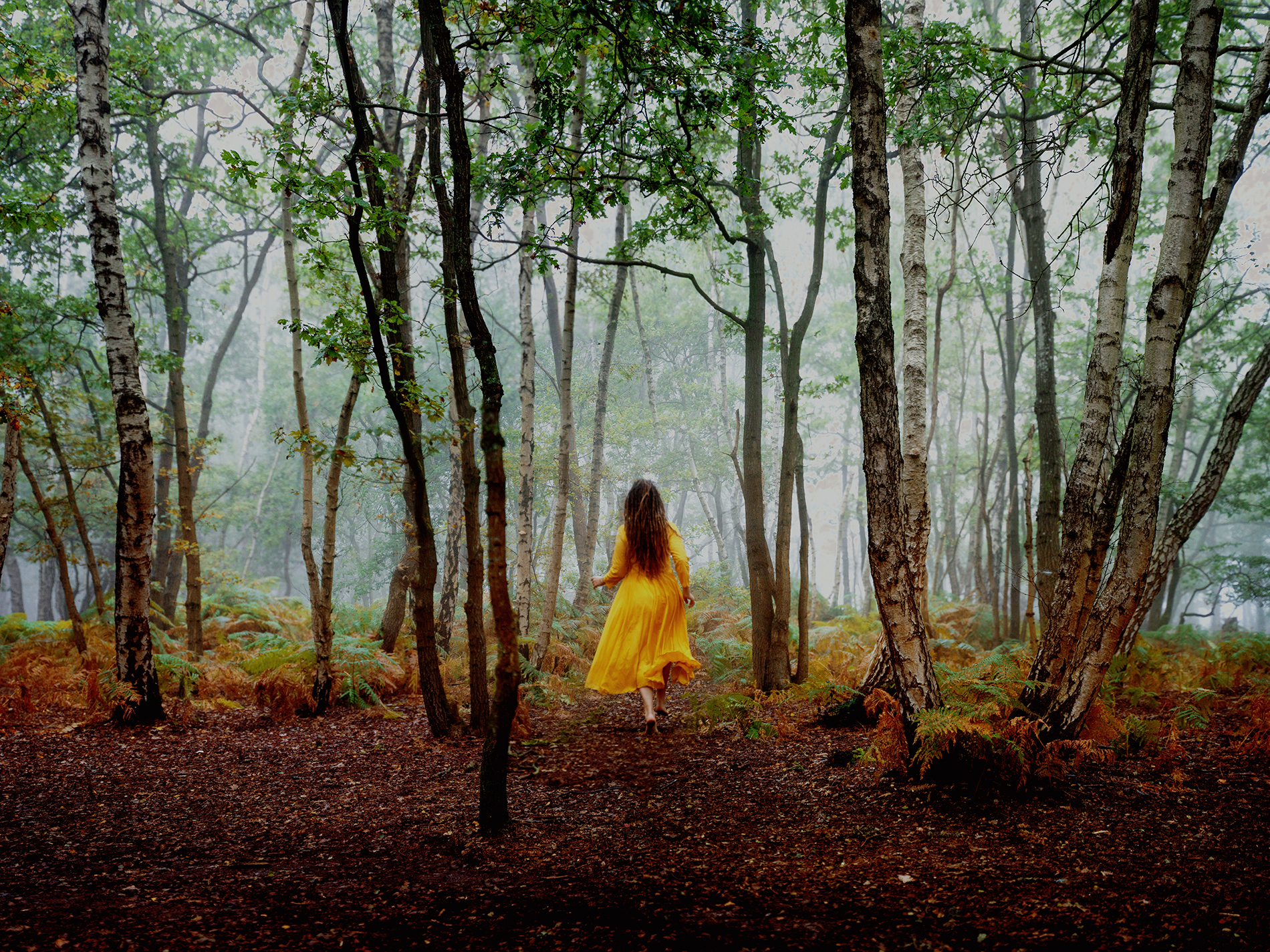 Discover artist date ideas to nurture your creative soul. The image shows a woman running barefoot through the forest.