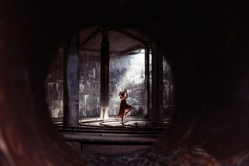Self portrait of a woman dancing in an abandoned building.