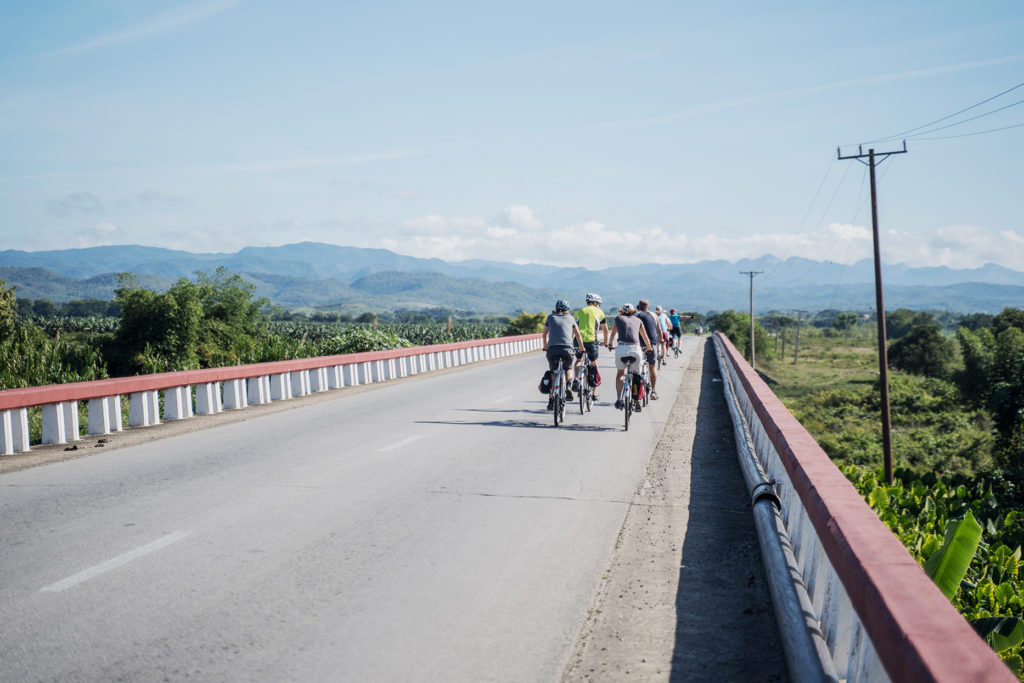 A group of tourists exploring rural Cuba by bicycle.