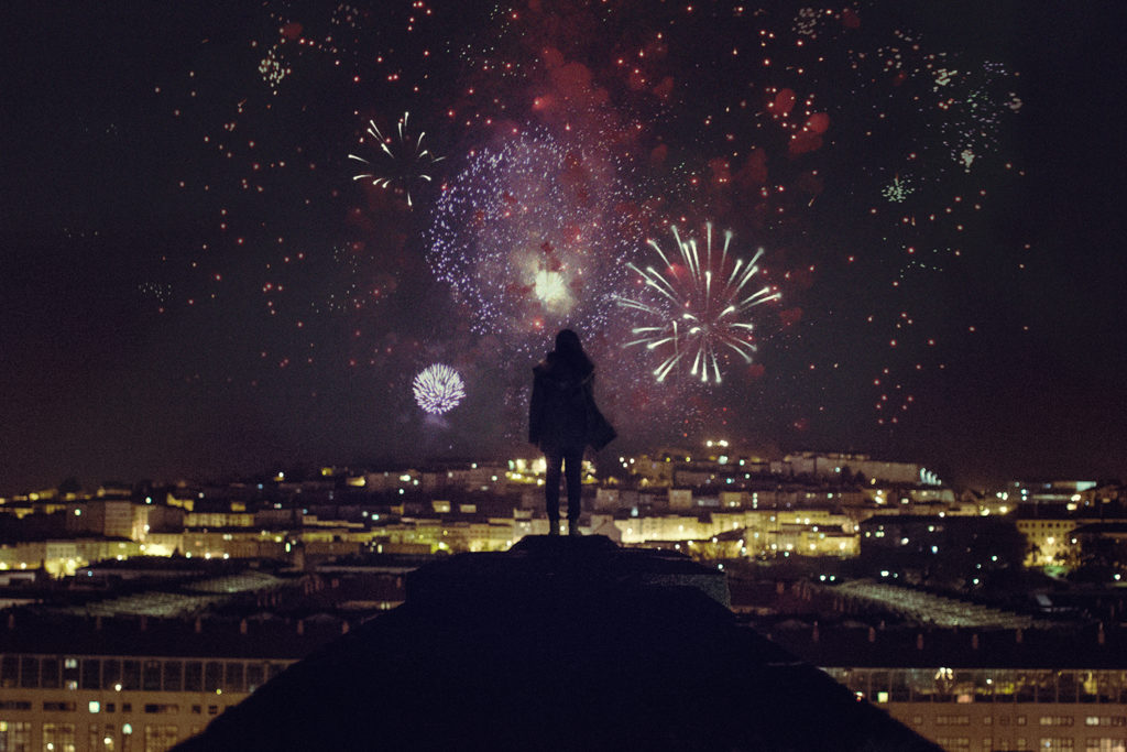 Traveling is like experiencing a firework of feelings everyday - self portrait above a city full of fireworks.
