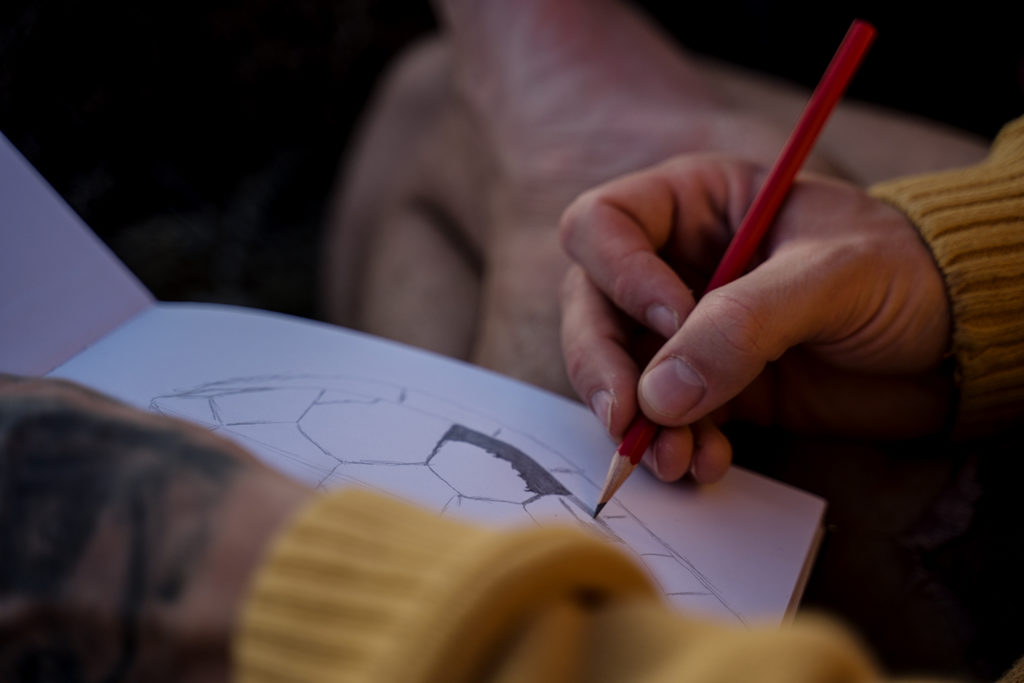 A man sketching in his creativity practice.