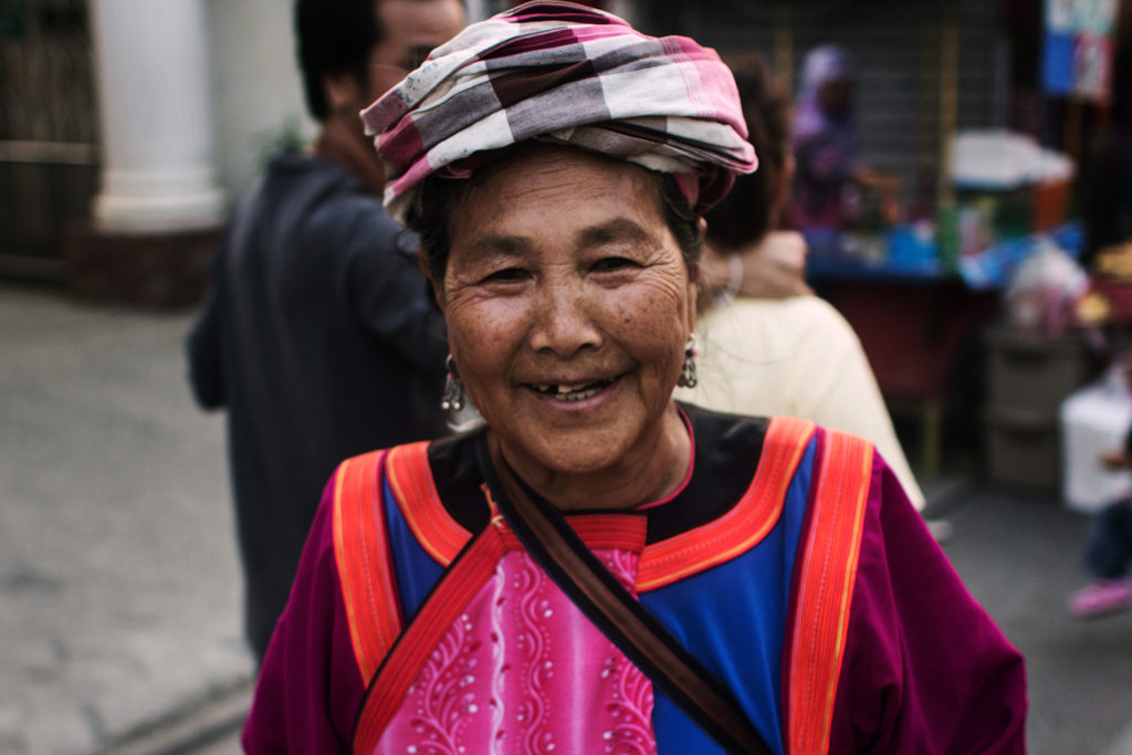 Photographing strangers and their smiles can brighten your day - here I photographed a street vendor.