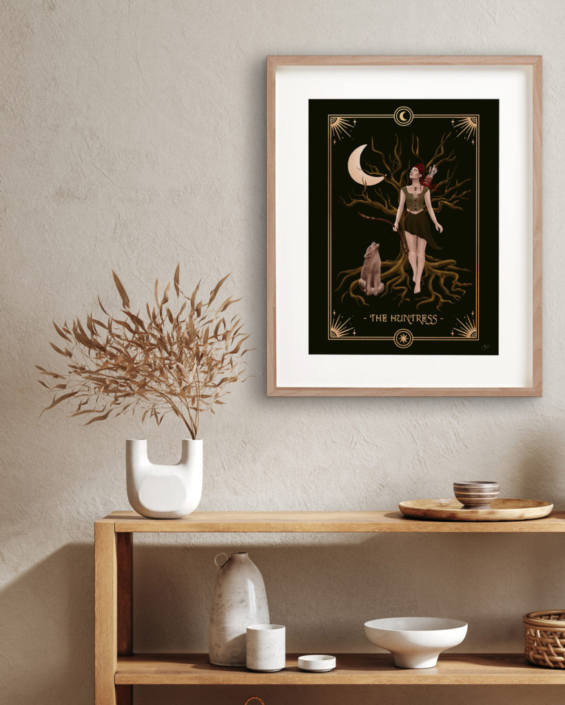 Modern kitchen interior with a big framed print representing the Huntress Archetype.