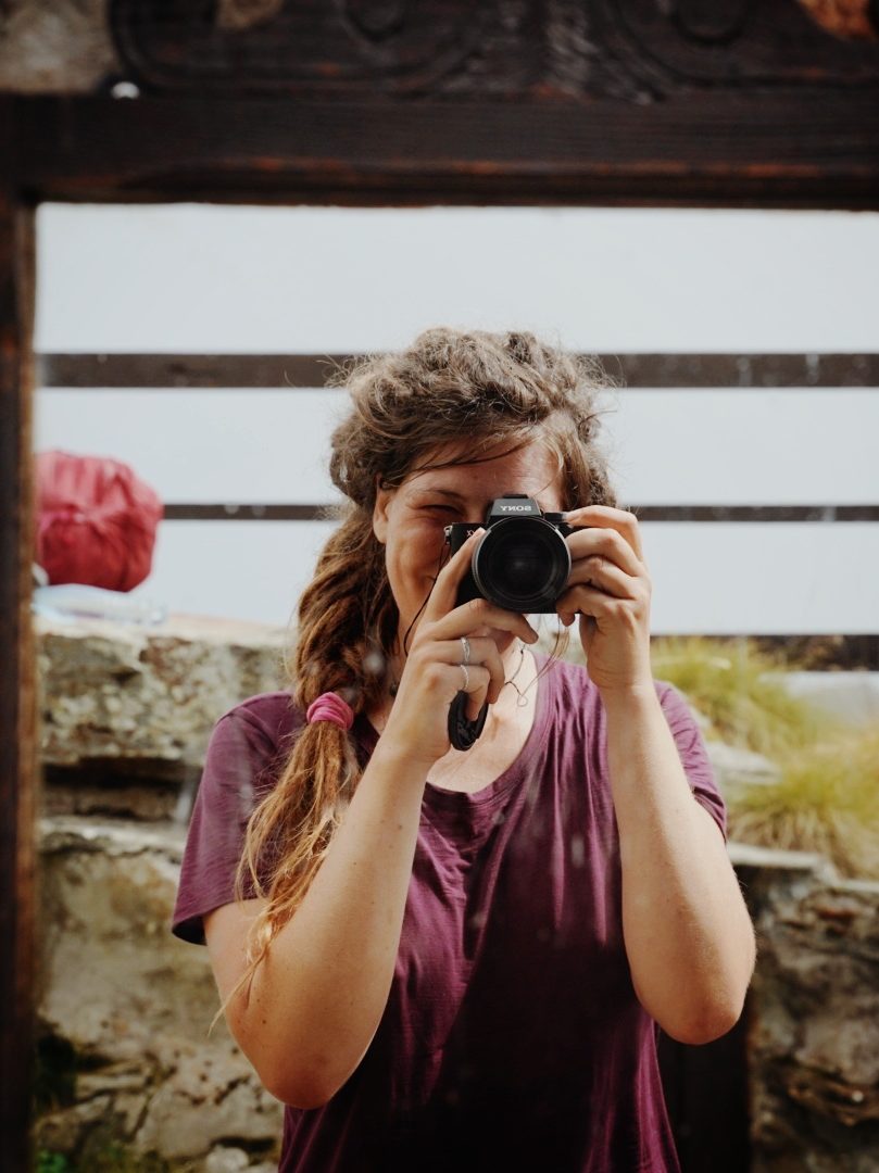 A portrait photographer taking a mirror selfie.