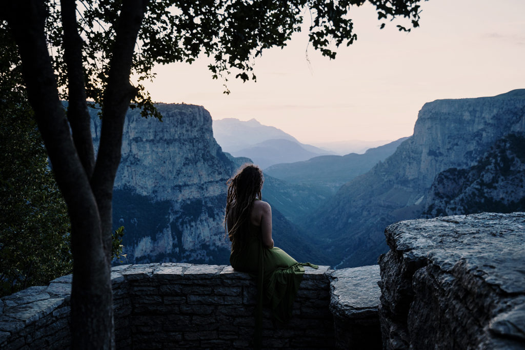A woman taking in the view of a beautiful canyon.
