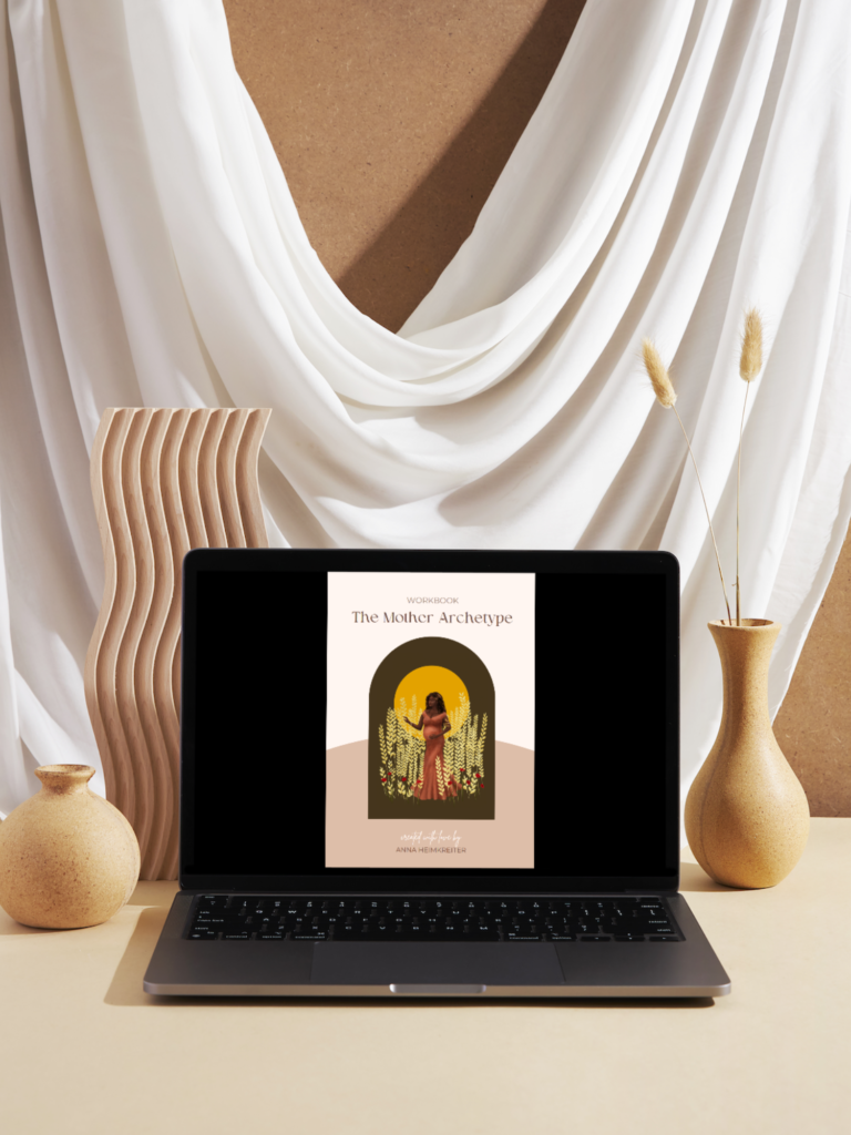 The Mother Archetype Workbook displayed on a laptop in a beautiful boho setting.